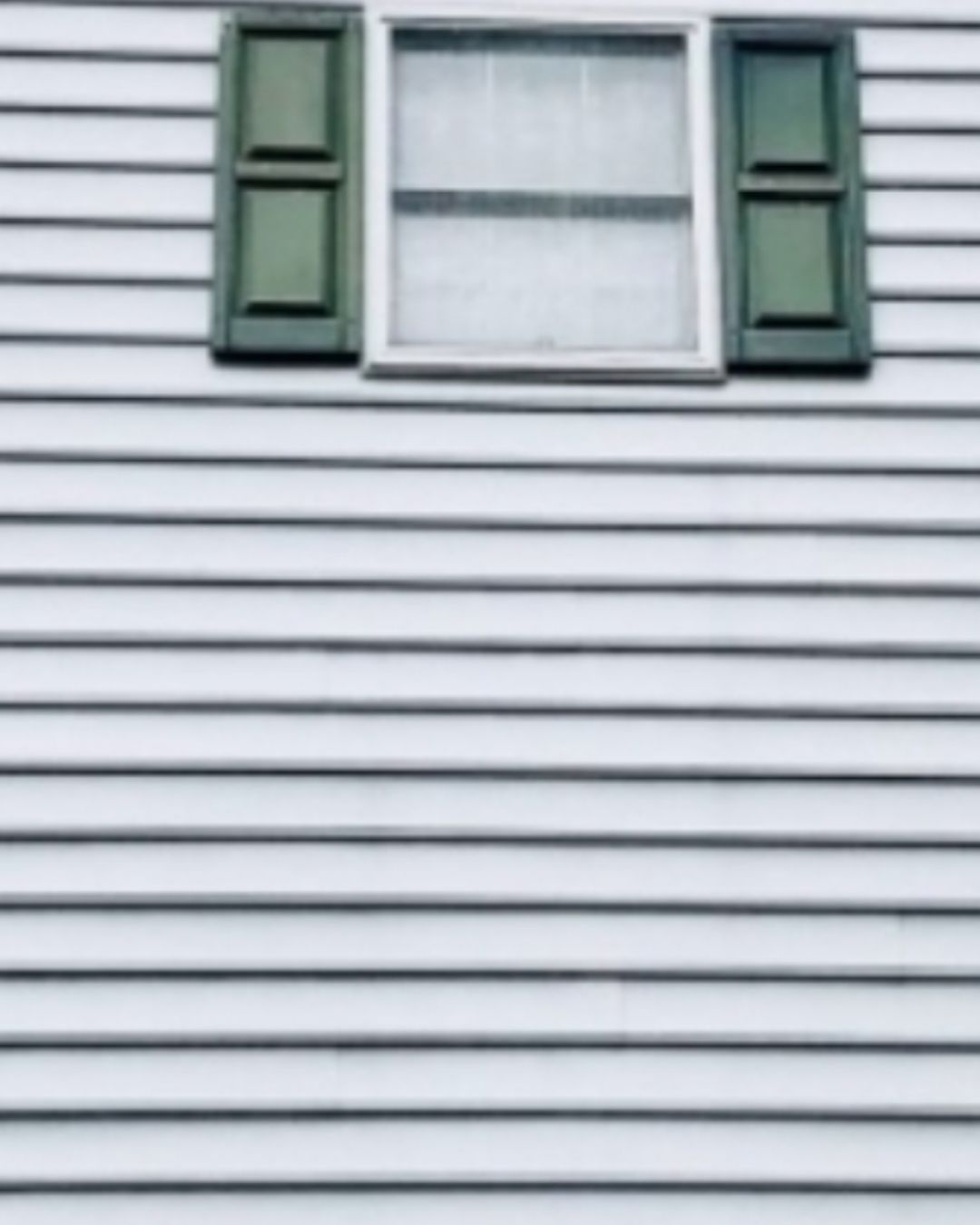 Clean house siding after professional pressure washing.