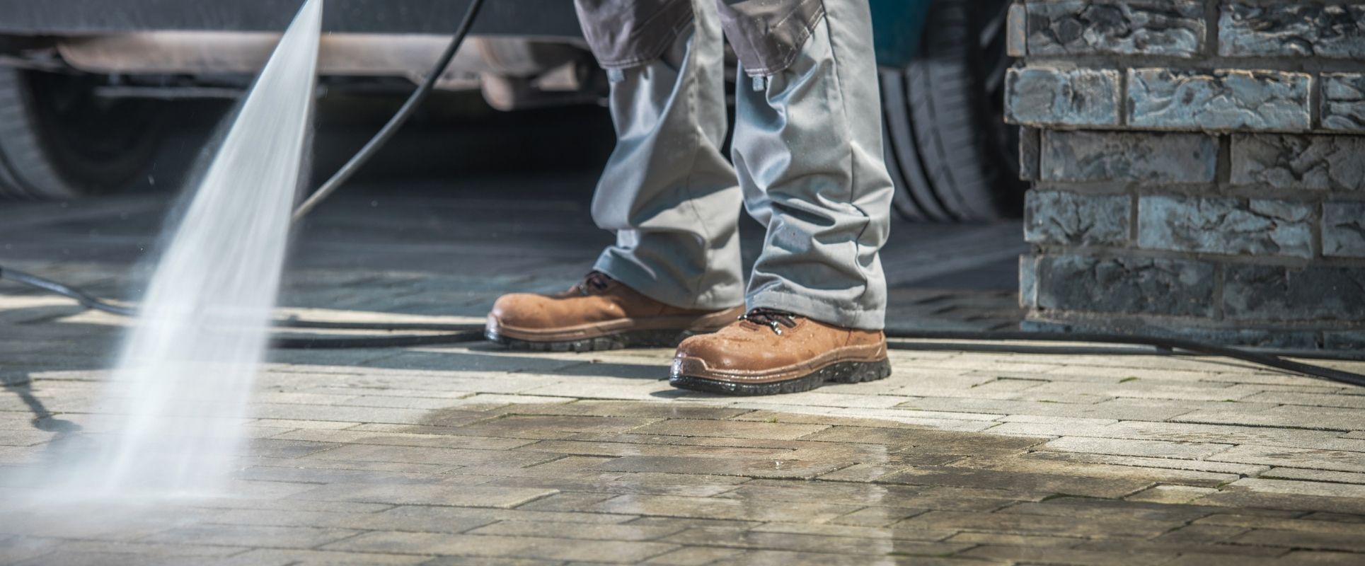 Pressure washing a driveway for a clean and refreshed surface.